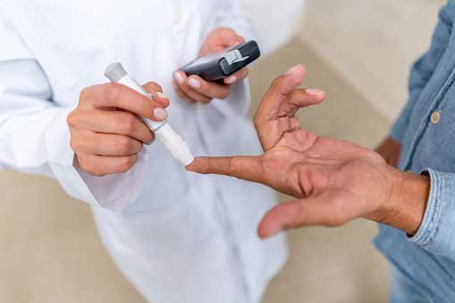 a man getting his blood sugar checked by a doctor